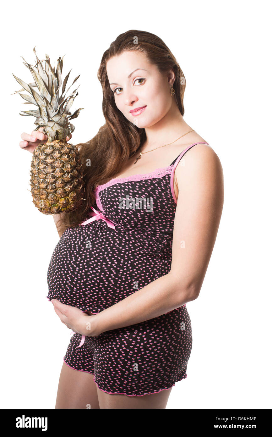 pregnant woman with fresh pineapple on isolated white background The concept of food and healthy