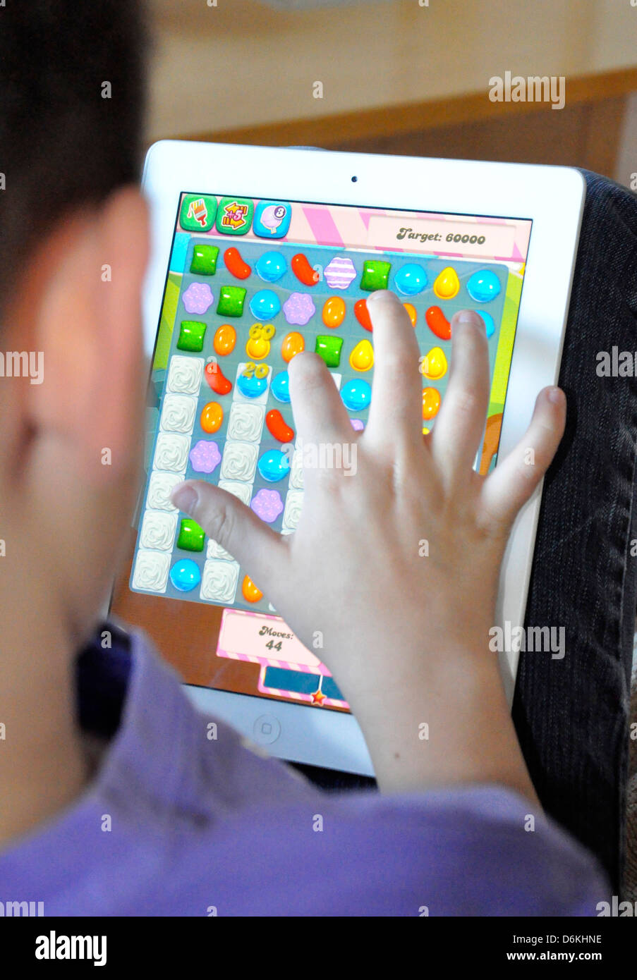 candy crush saga game ipad boy playing addicted winning concentrate game child Stock Photo