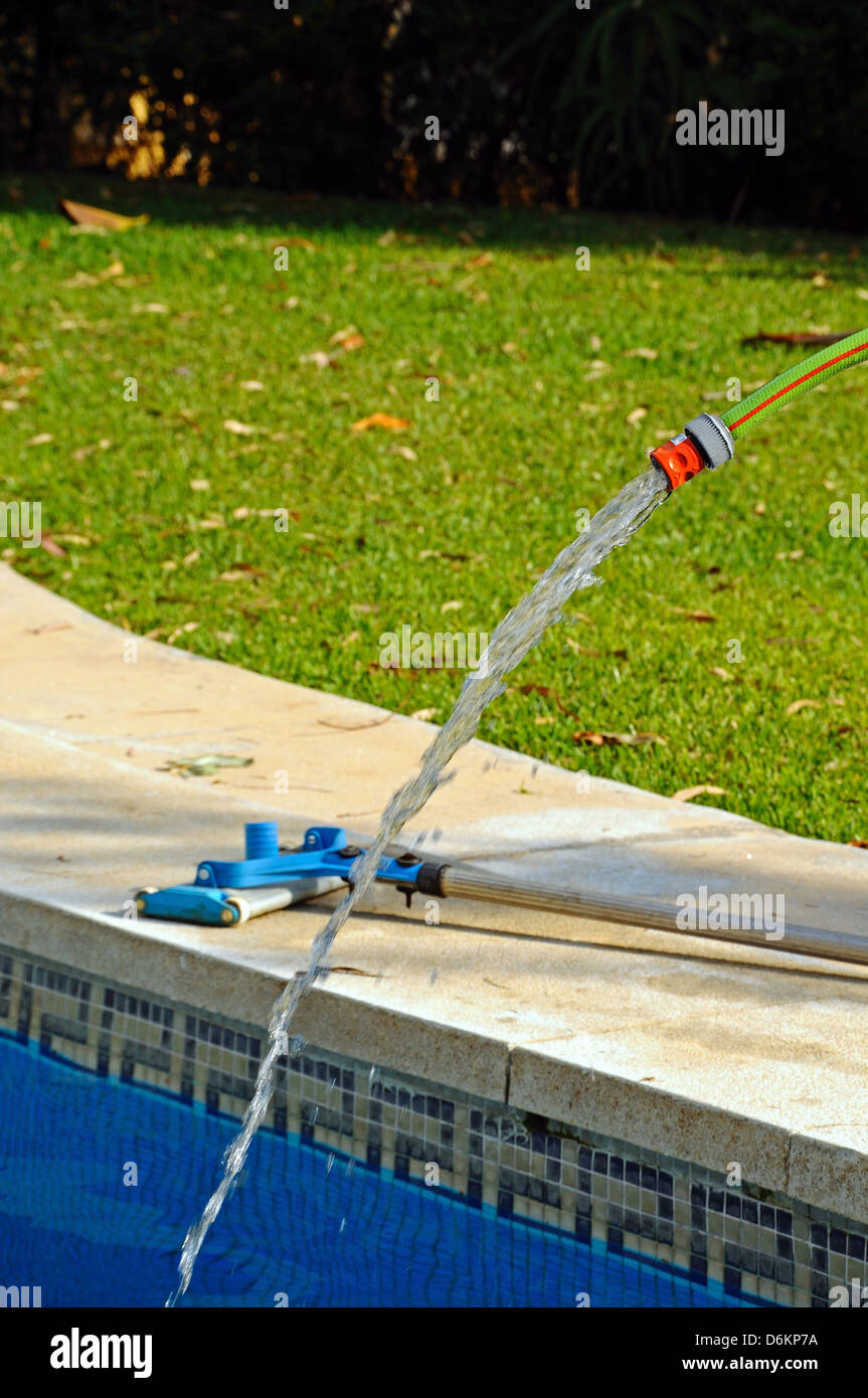 Garden hose filling swimming pool, Calahonda, Costa del Sol, Andalucia