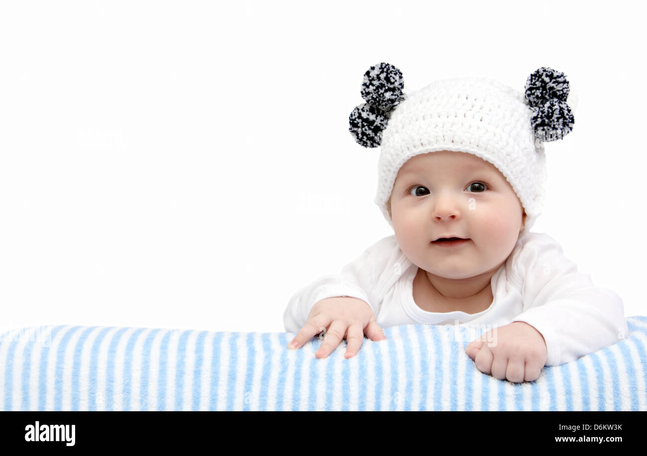 happy baby in white knitted hat Stock Photo