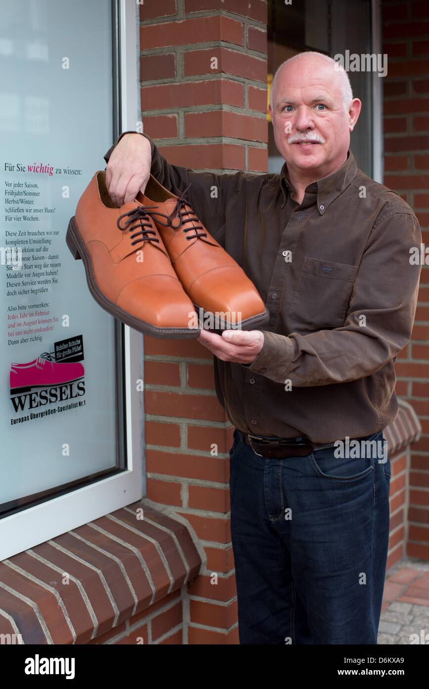Shoemaker Georg Wessels presents a pair of oversized men's shoes in front  of his shop in Vreden, Germany, 15 April 2013. Wessels manufactures shoes  for people with large shoe sizes all around
