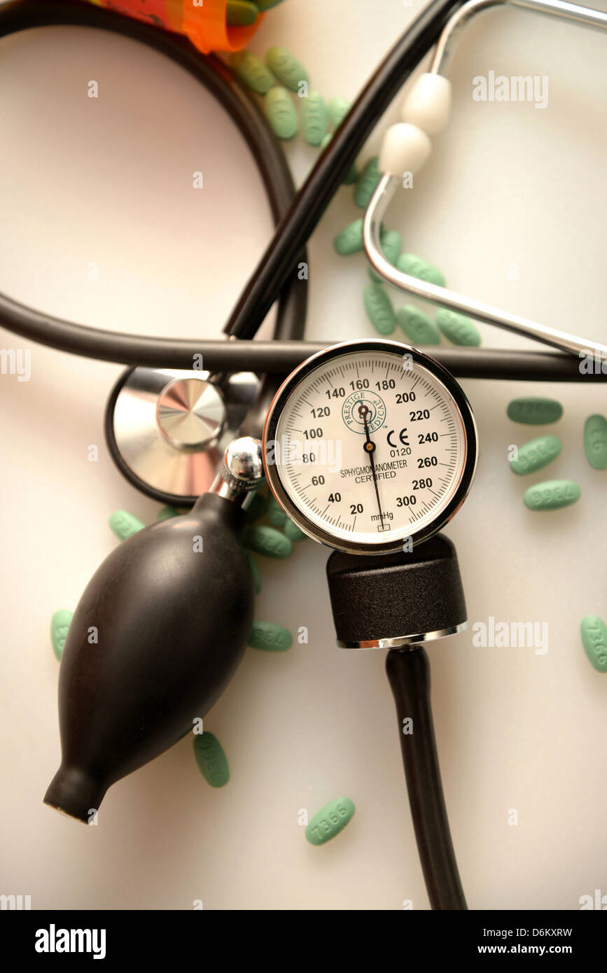 A blood pressure cuff, or sphygmomanometer, a stethoscope and Losartan 100 mg tablets, used to treat hypertension. Stock Photo