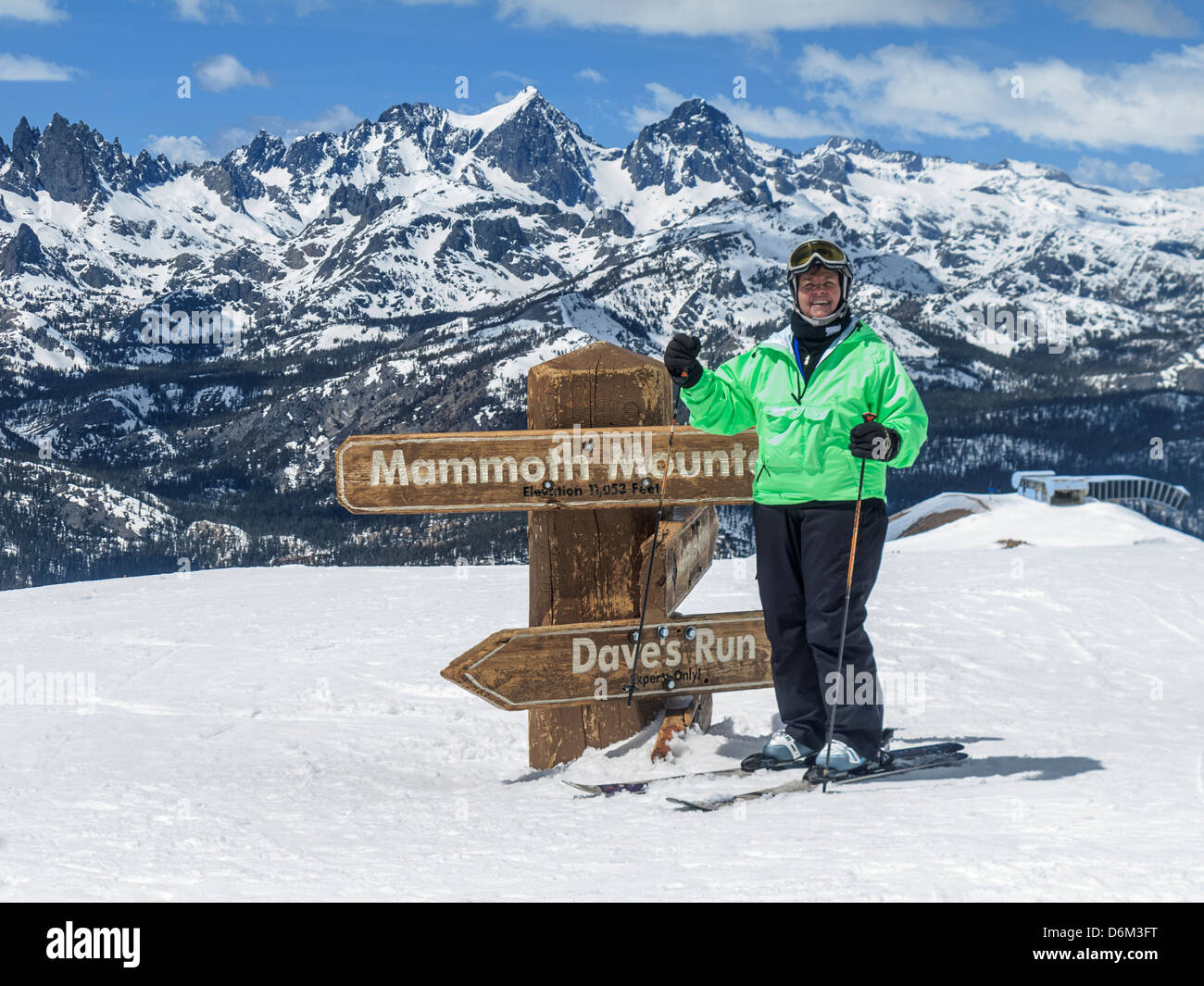 Woman wearing fancy ski wear at the top of Mammoth Mountain's expert runs, ready to put the technical skiwear through its paces. Stock Photo