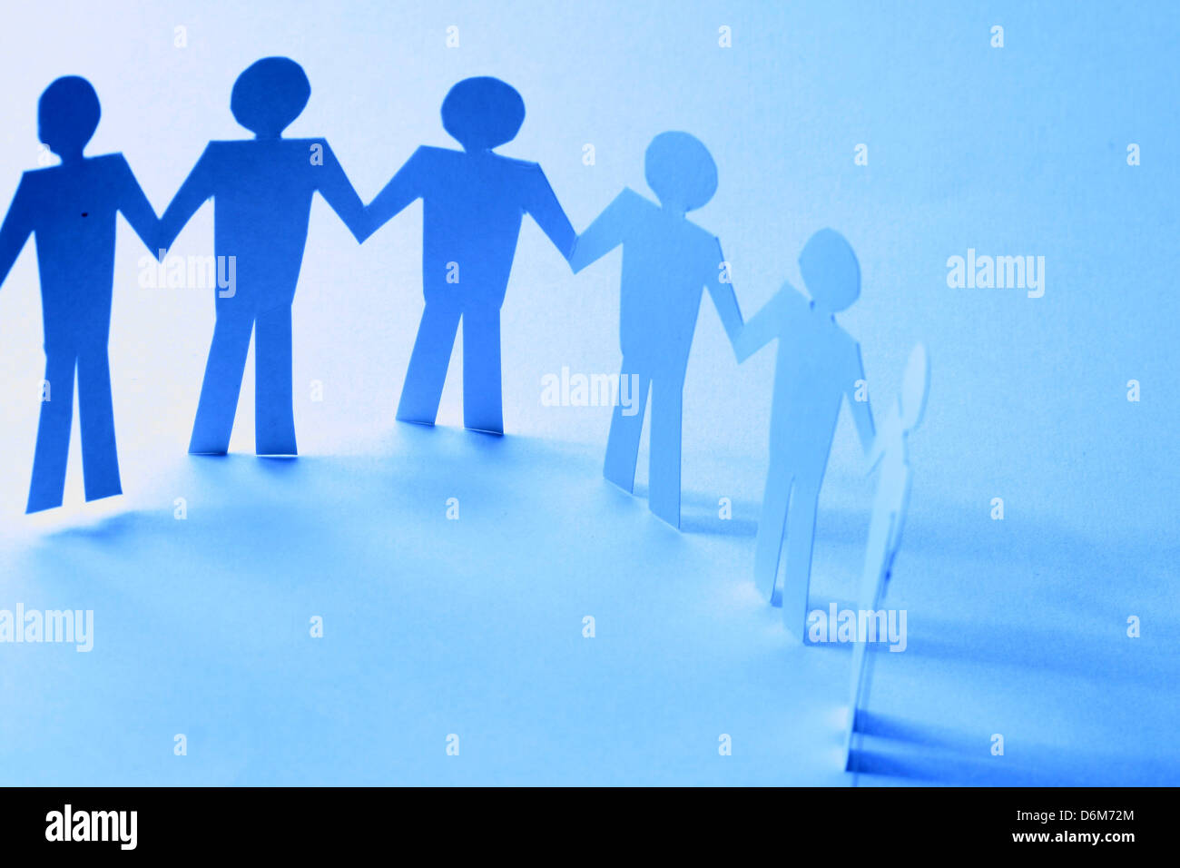 paper team linked together partnership concept Stock Photo