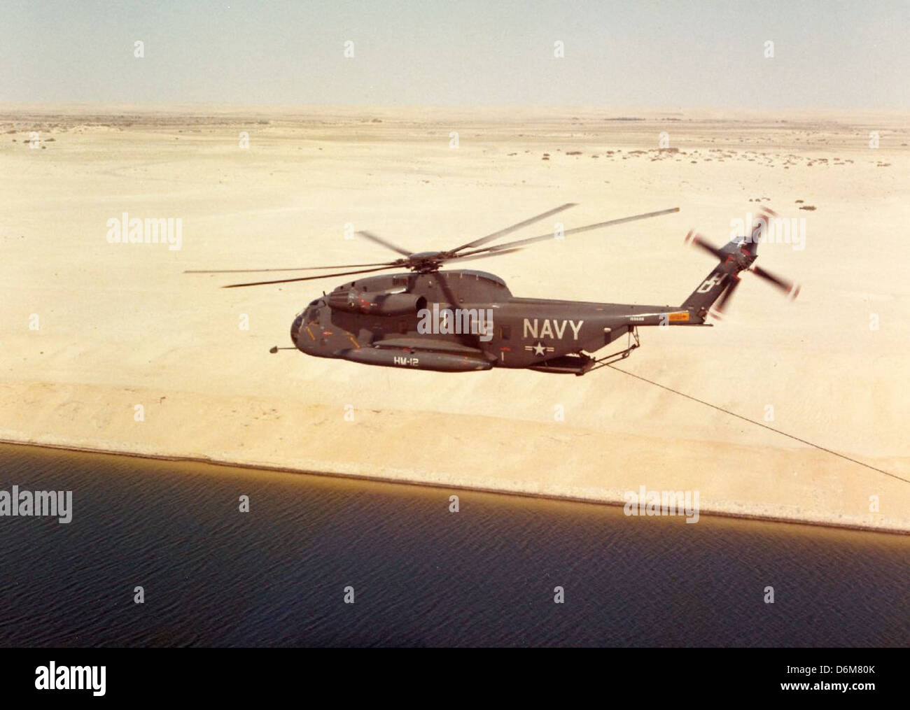 The Navy H-53 helicopter is part of the Sikorsky H-53 family, primarily used for heavy-lift and search and rescue operations by the U.S. Navy. Its versatility and performance make it a key asset in naval aviation and military operations. Stock Photo