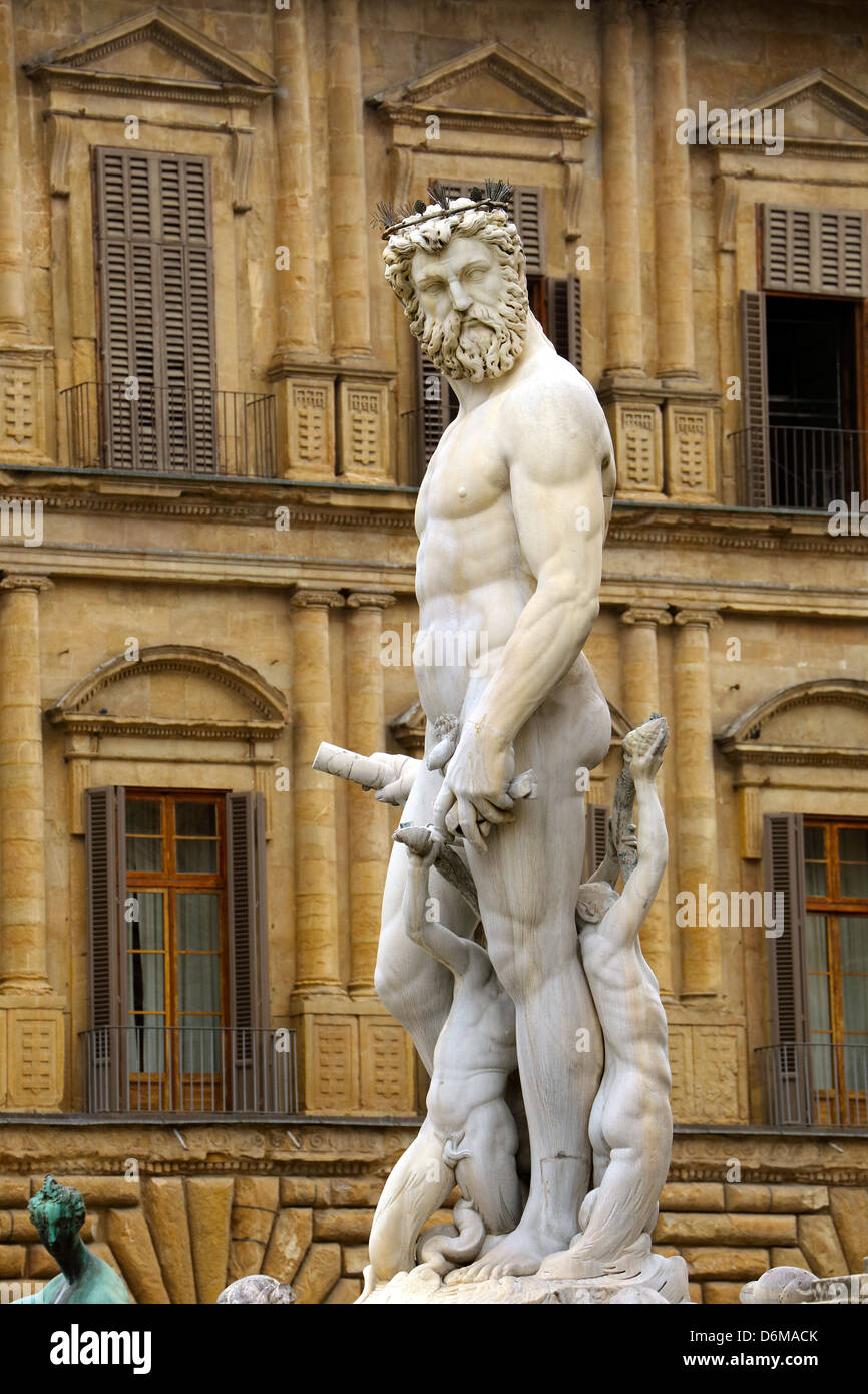 Statue of Neptune that is part of Fontana di Nettuno standing in Piazza della Signoria in Florence Italy Stock Photo