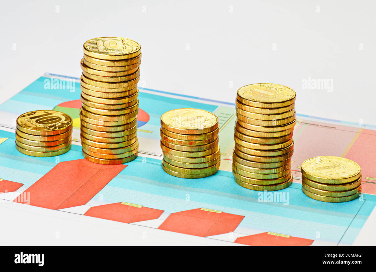 Coins on multi-colored graph. Selective focus Stock Photo