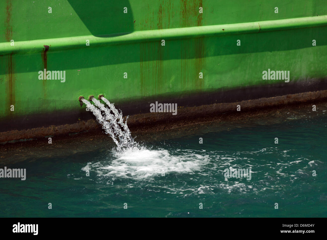 Water coming out from a ship for cooling the engine Stock Photo