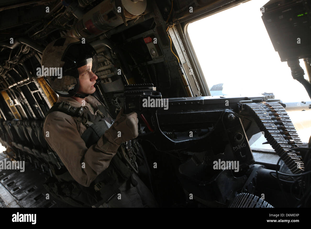 A US Marine door gunner provides security from a CH53E Super Stock