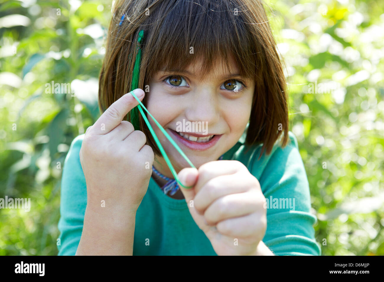 8 year old girl snapping rubber band Stock Photo Alamy