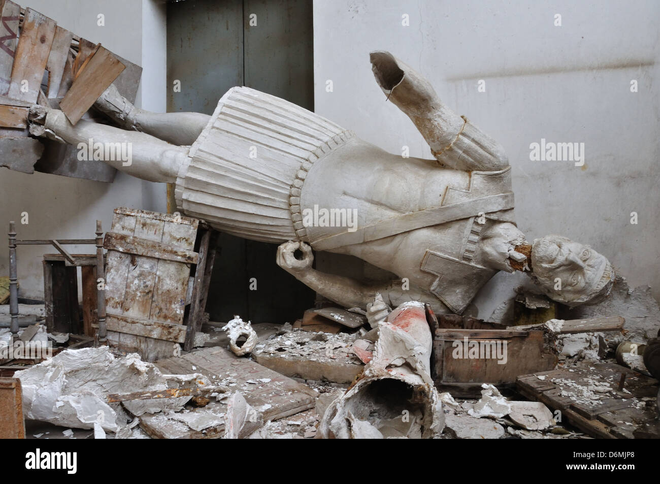 Broken statue gigantic figure ancient god in the abandoned vandalized