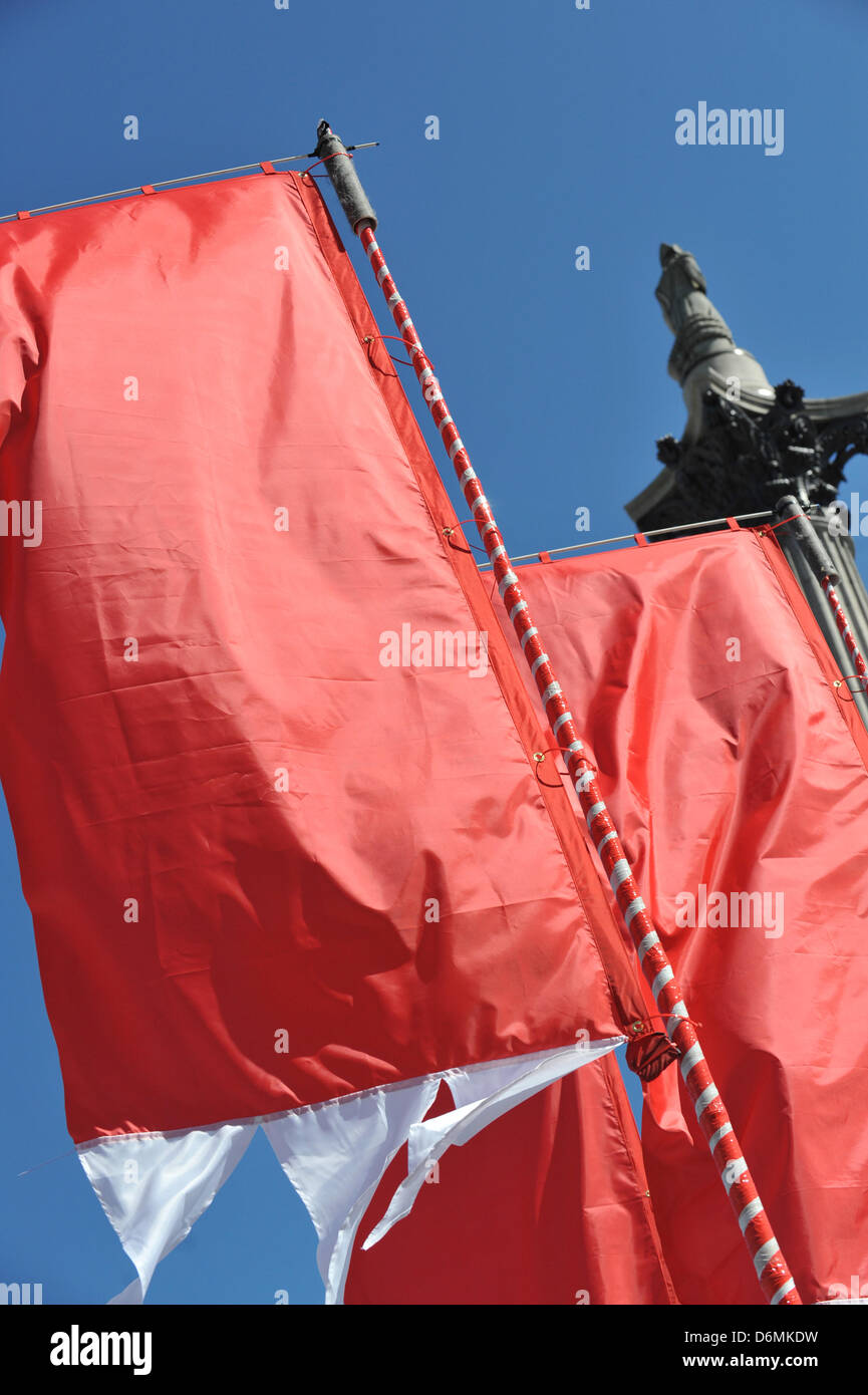 Trafalgar Square, London, UK. 20th April 2013. Flags and Nelson's Column at the Feast of St George. The Feast of St George in Trafalgar Square to celebrate food glorious food. The Mayor of London is inviting Londoners and visitors to a Feast of St George, a celebration of English food, including an English Food Market, a 5 metre Dragon, Jugglers, Jesters and Minstrels to entertain the crowd. Credit: Matthew Chattle/Alamy Live News Stock Photo