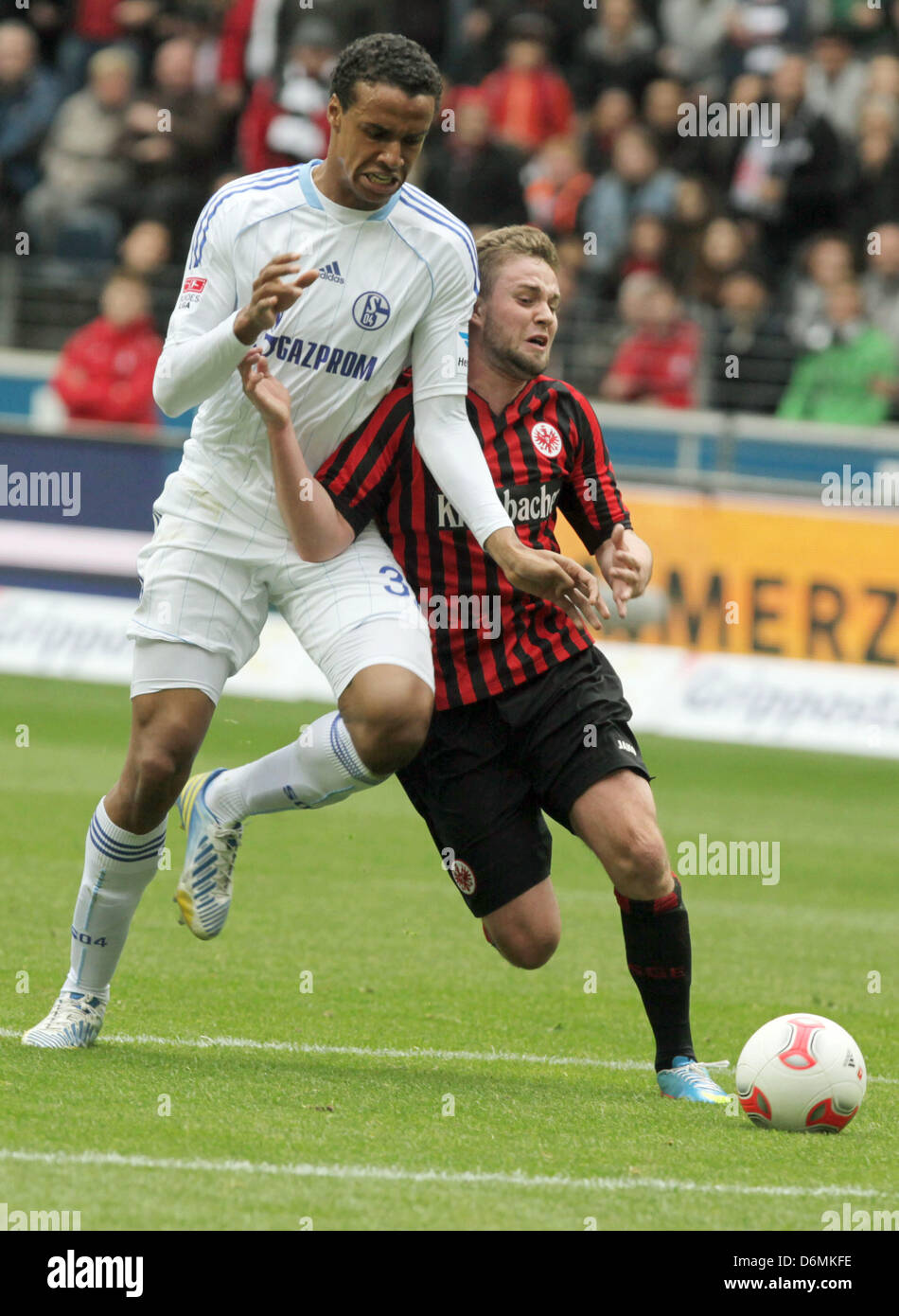 Schalke's Joel Matip (L) vies for the ball with Frankfurt's Marc Stendera (R) during the Bundesliga match Eintracht Frankfurt vs FC Schalke 04 at the Commerzbank-Arena in Frankfurt/Main, Germany, 20 April 2013. Photo: FRANK RUMPENHORST   (ATTENTION: EMBARGO CONDITIONS! The DFL permits the further  utilisation of up to 15 pictures only (no sequntial pictures or video-similar series of pictures allowed) via the internet and online media during the match (including halftime), taken from inside the stadium and/or prior to the start of the match. The DFL permits the unrestricted transmission of dig Stock Photo