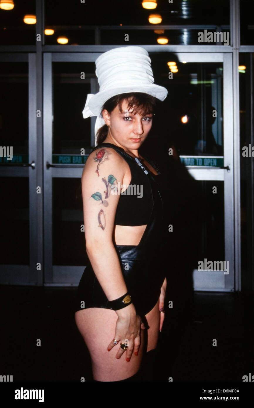 pretty female in white hat with tattoos at the dunstable tattoo and body piercing expo 1995 Stock Photo