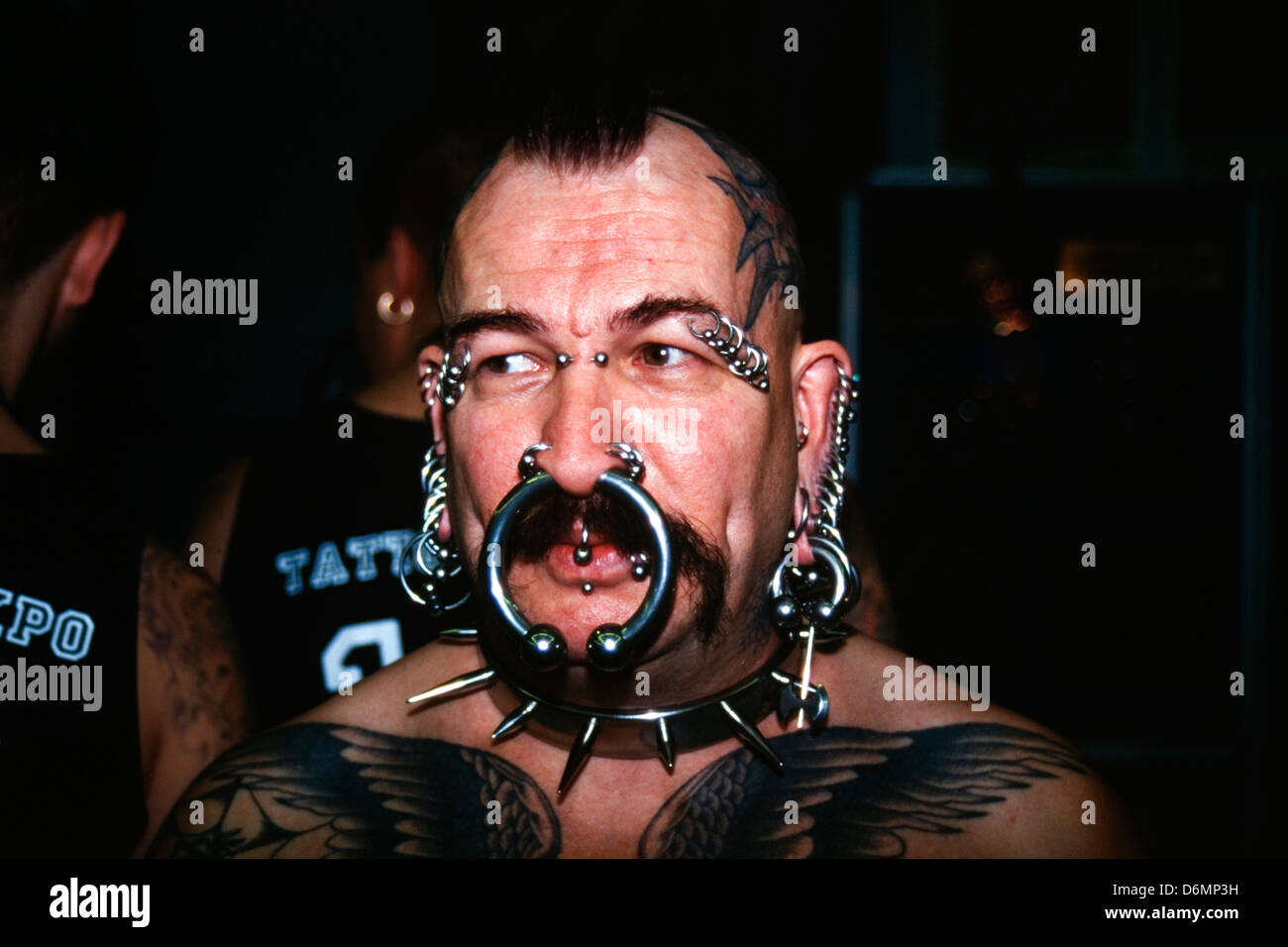 heavily tattooed and pierced man at the dunstable tattoo and body piercing expo 1995 Stock Photo
