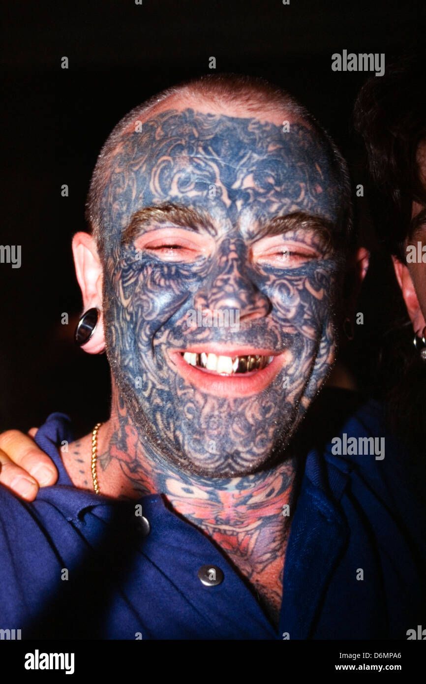 man with full facial tattoos laughing at the dunstable tattoo and body piercing expo 1995 Stock Photo