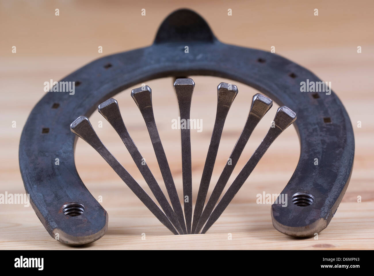 new horseshoe with nails lies on board Stock Photo Alamy