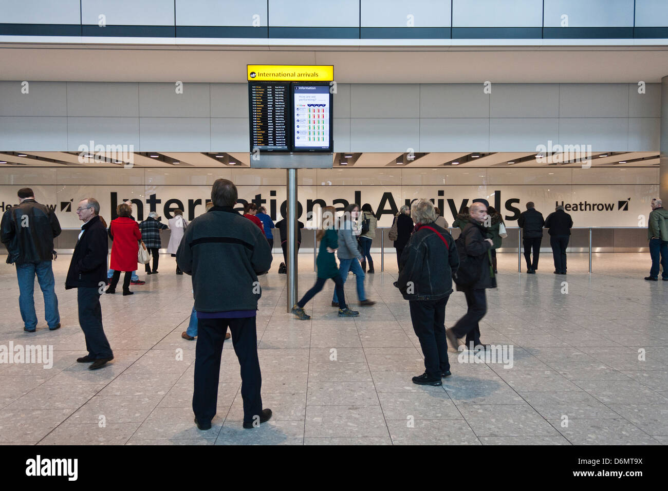 Terminal five, Heathrow Airport, London. International Arrivals area with information screen. Stock Photo