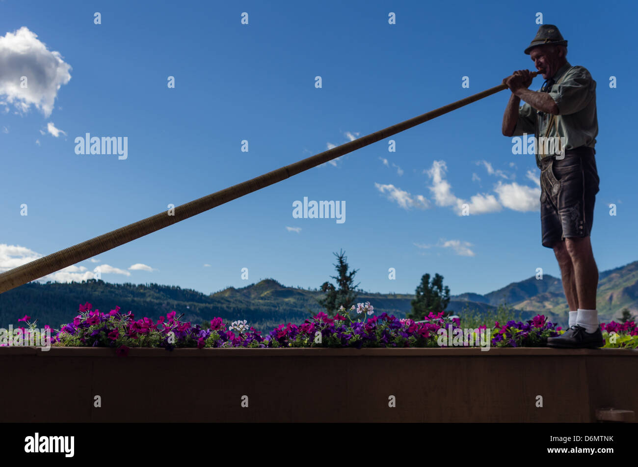 Man playing an Alpenhorn in Leavenworth, Washington, USA Stock Photo