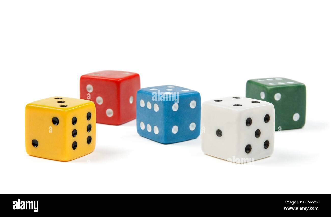 Five dices of different colors on white background. Stock Photo