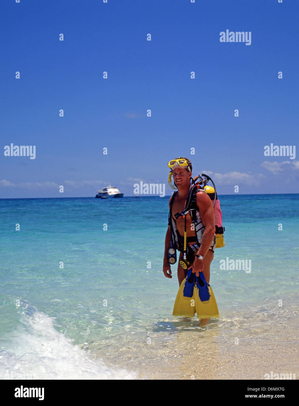 Young male scuba diver on tropical cay, Great Barrier Reef, Queensland, Australia Stock Photo