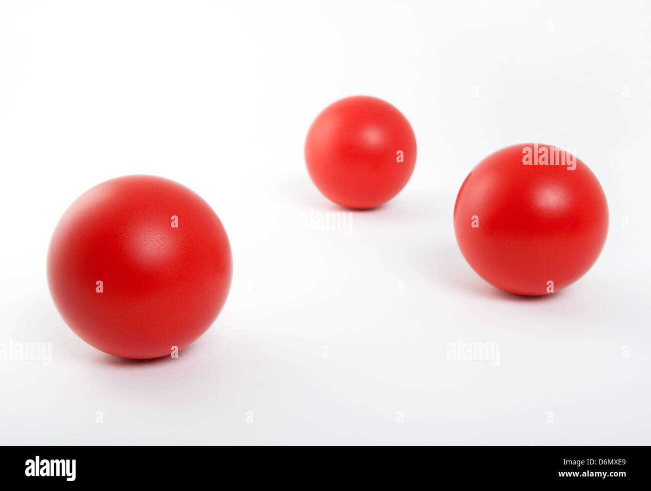 Three red rubber balls isolated on white background Stock Photo Alamy