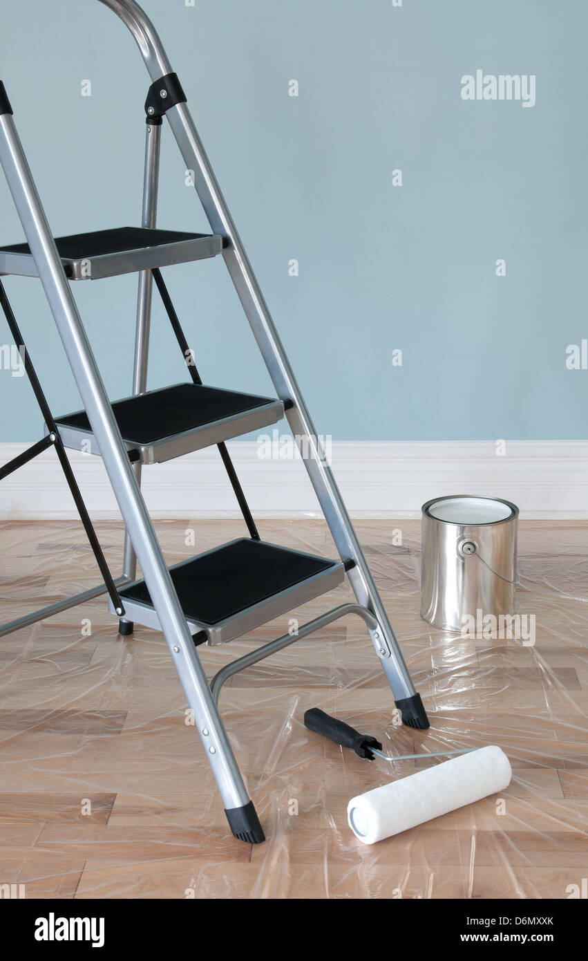 Room prepared for painting. Ladder, painting tools and floor protected ...
