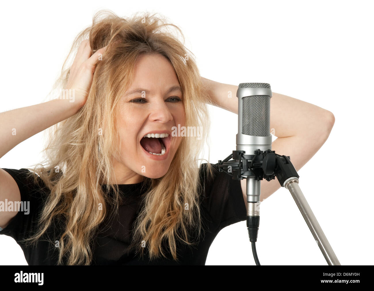 Female rock singer screaming to the microphone. Isolated on white
