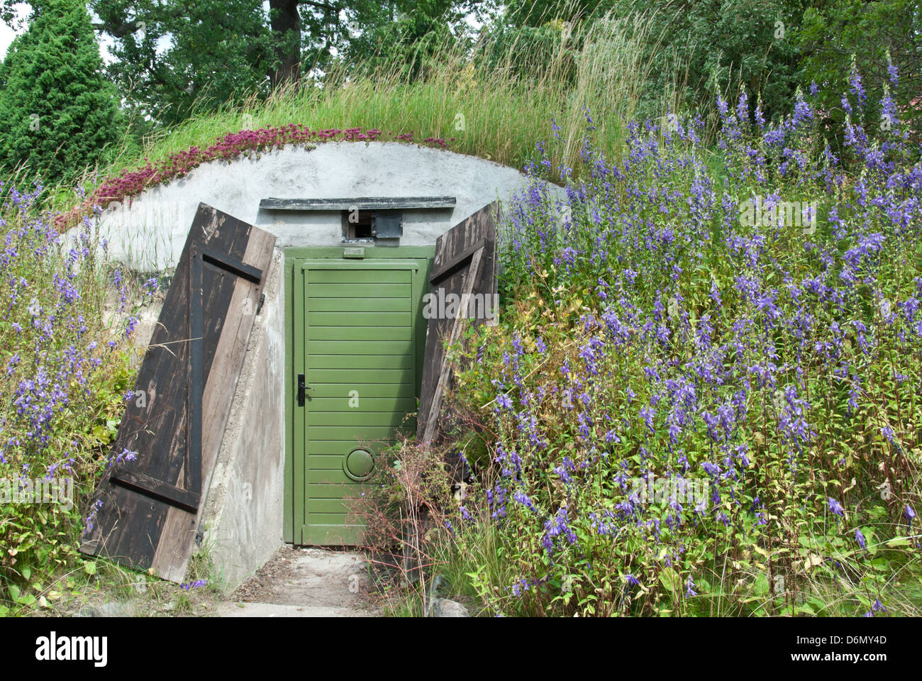 Door to an underground dwelling built under a hill. Stock Photo