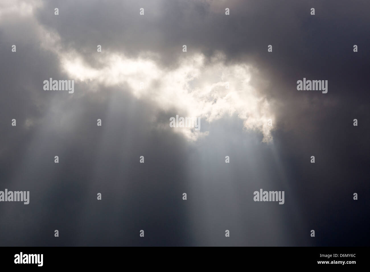 Sun shining through clouds Stock Photo - Alamy