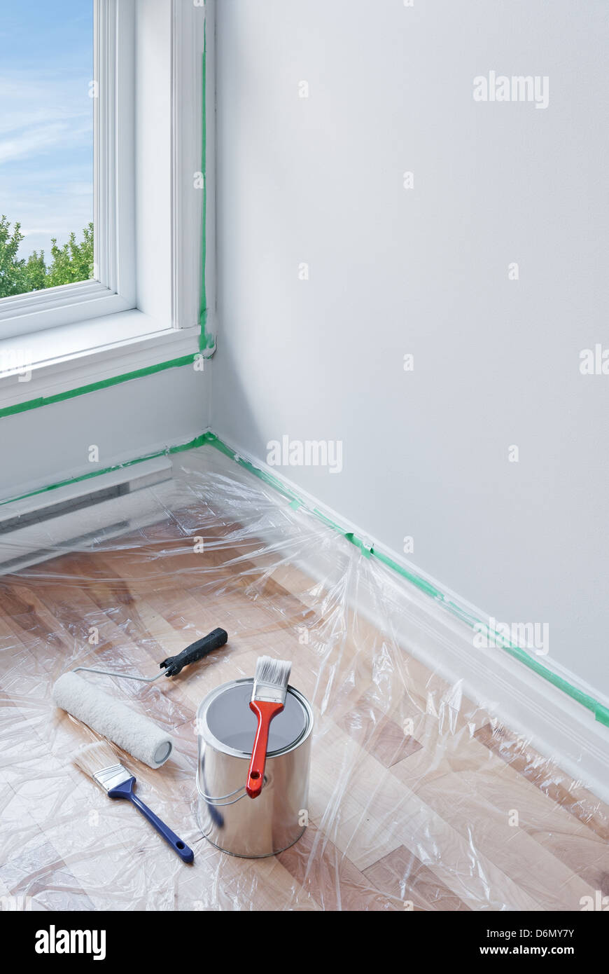 Renovations. Painting tools and floor protected by plastic Stock Photo ...