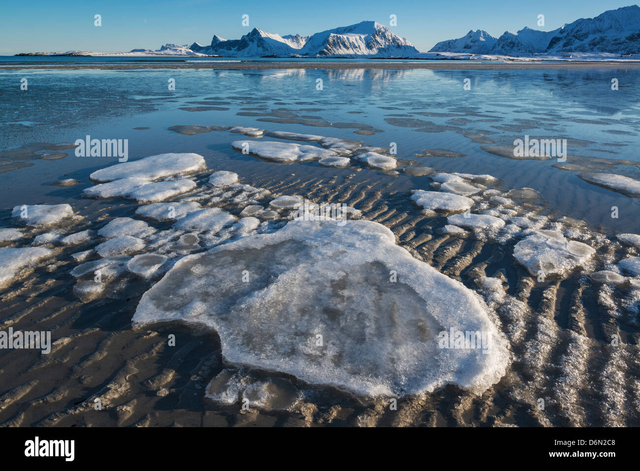 Frozen sea ice on beach, Sandbotnen, Ytresand, Flakstadøy, Lofoten Islands, Norway Stock Photo