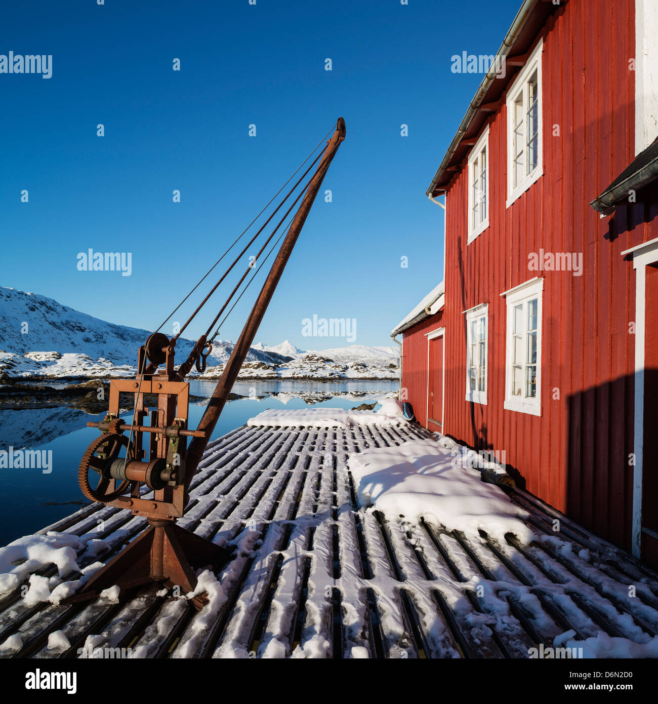 Snow covered deck outside red Rorbu building, Steine, Vestvågøy, Lofoten Islands, Norway Stock Photo