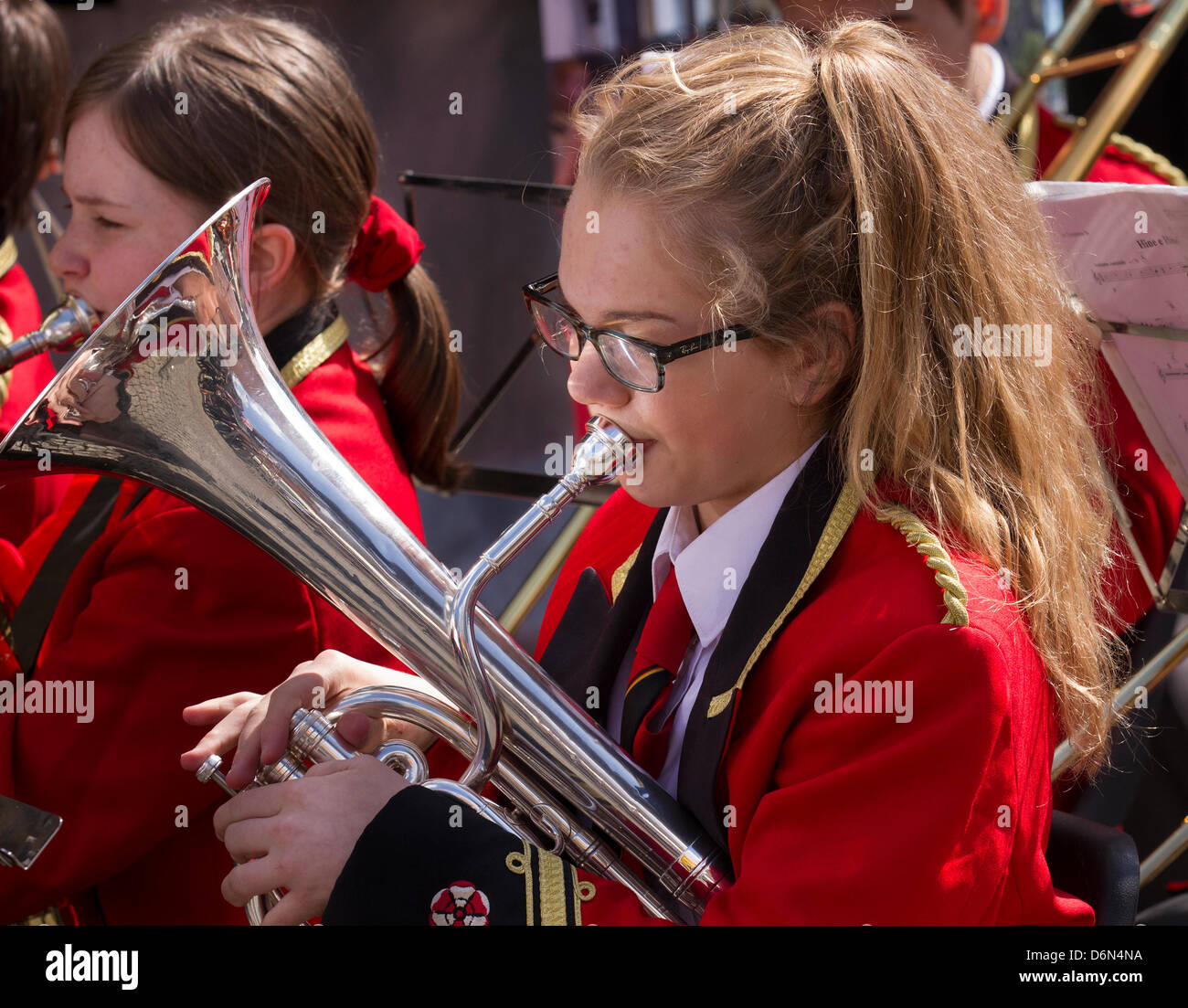 Manchester, UK. 20th April, 2013. Young female musicians of the Dobcross Orchestra Youth Band play at the St George's day celebrations, a group event held in Albert Square and Piccadilly, an extension of the annual St George Parade to celebrate England's Patron Saint, with many musical performers various instruments and entertainers playing. Stock Photo