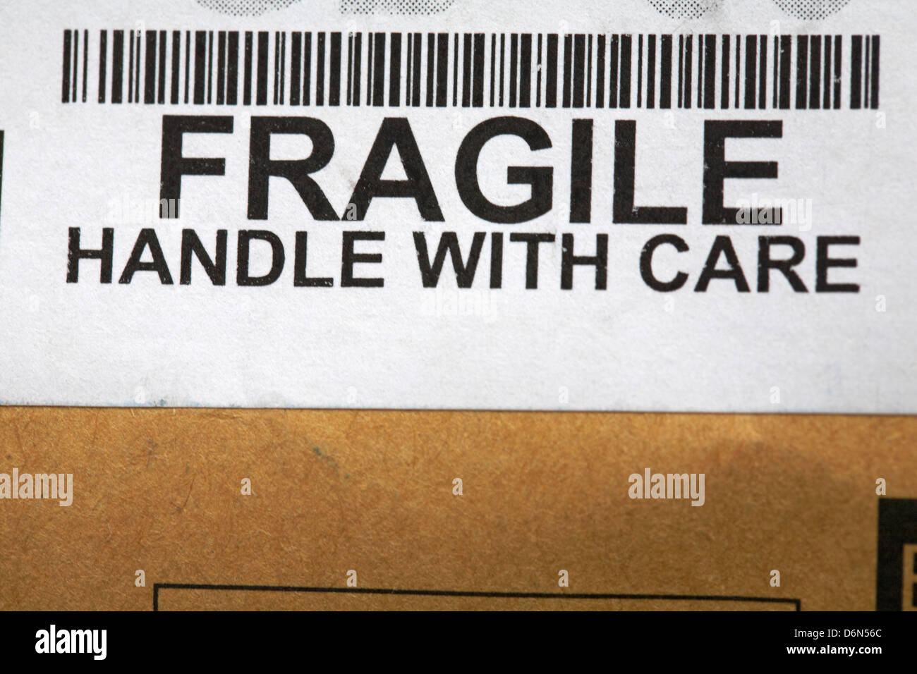 fragile handle with care sticker and barcode on package packaging box Stock Photo