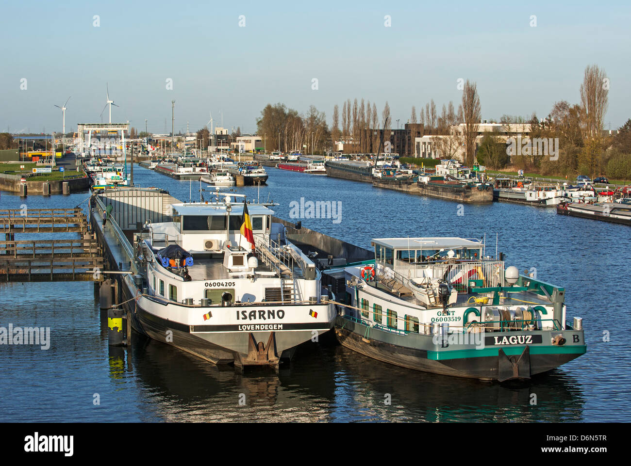 Inland navigation vessels / cargo canal boats on the Ringvaart waiting at the Evergem lock to enter the Ghent port, Belgium Stock Photo