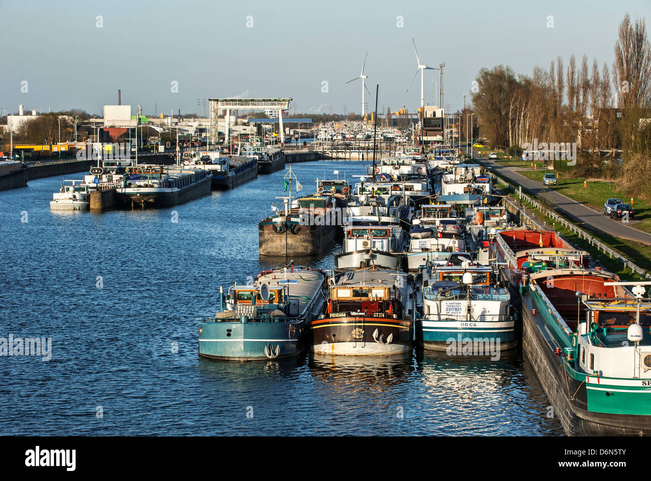 Inland navigation vessels / cargo canal boats on the Ringvaart waiting at the Evergem lock to enter the Ghent port, Belgium Stock Photo