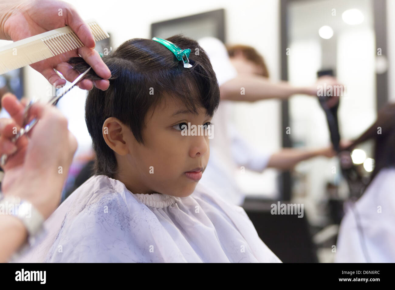 A young boy getting haircut in hair salon Stock Photo - Alamy