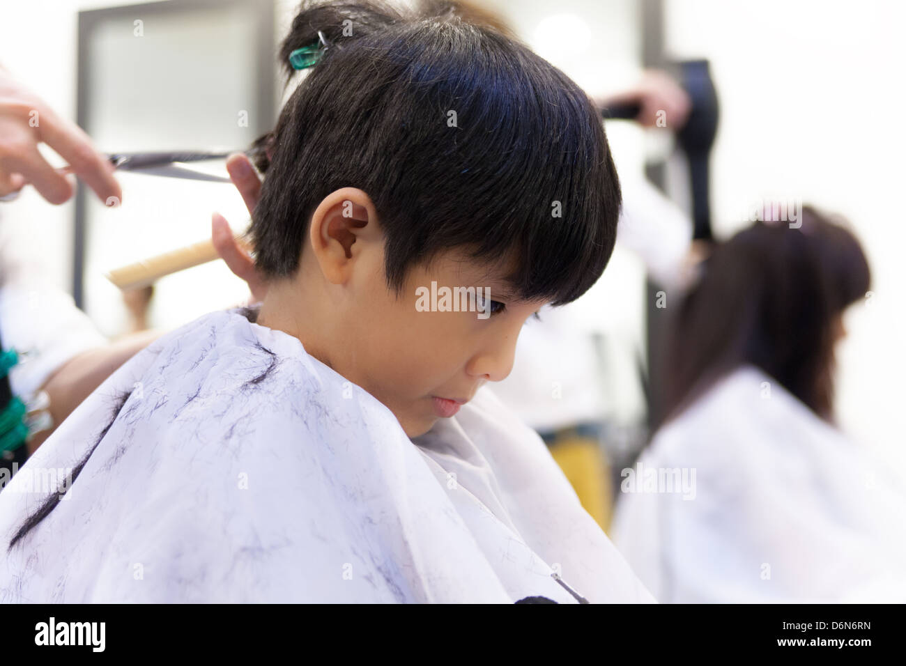 A Young Boy Getting Haircut In Hair Salon Stock Photo 55785401