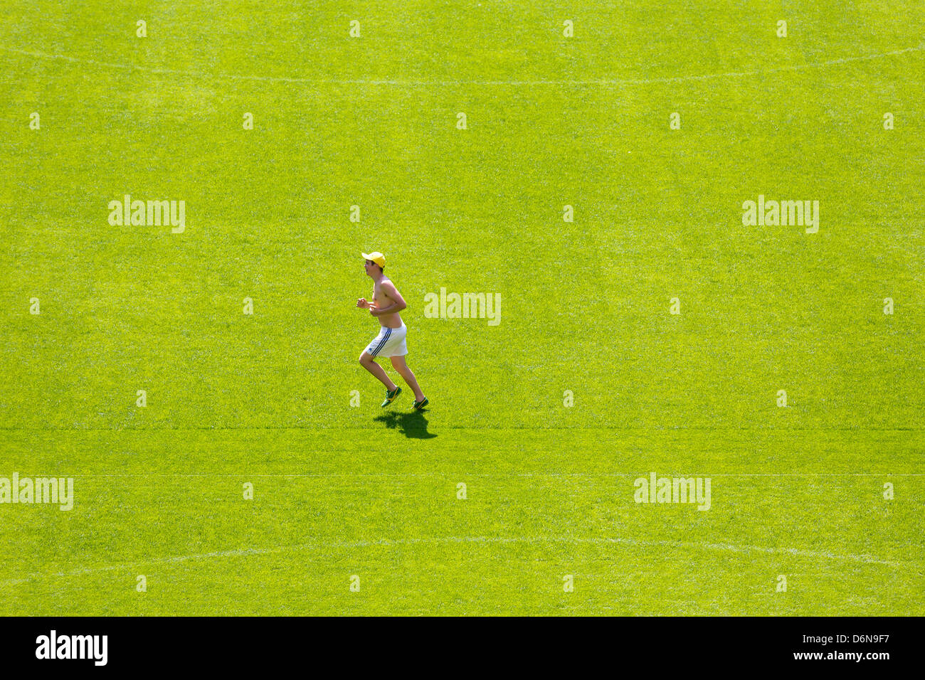 Lviv, Ukraine, a man runs over the freshly mowed lawn of the Arena Lviv, Spielstaette for the Euro 2012 Stock Photo