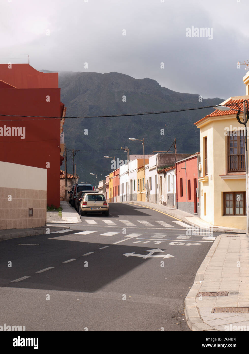 Quiet local street with traditional Spanish houses in Buenavista del Norte Tenerife Spain, Teno mountain backdrop Stock Photo