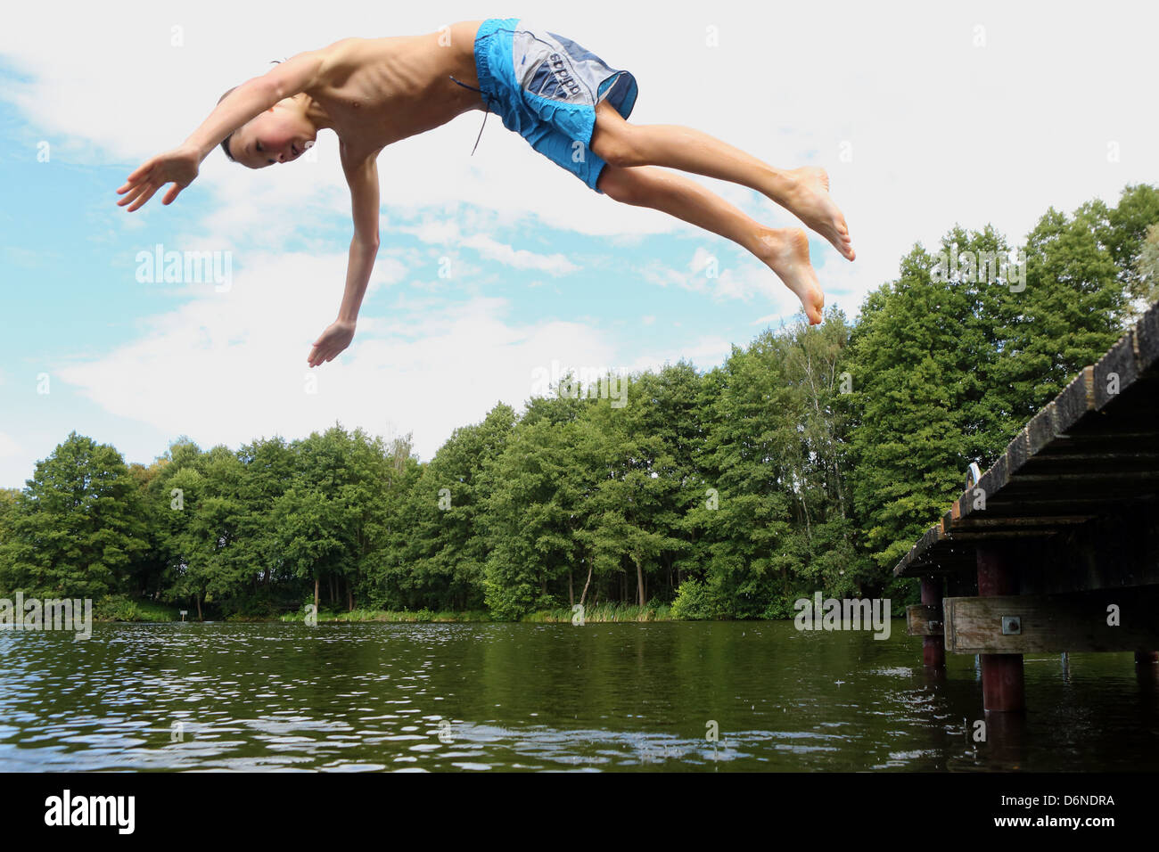 Emstal, Germany, boy jumps into the water in the pool head over Stock
