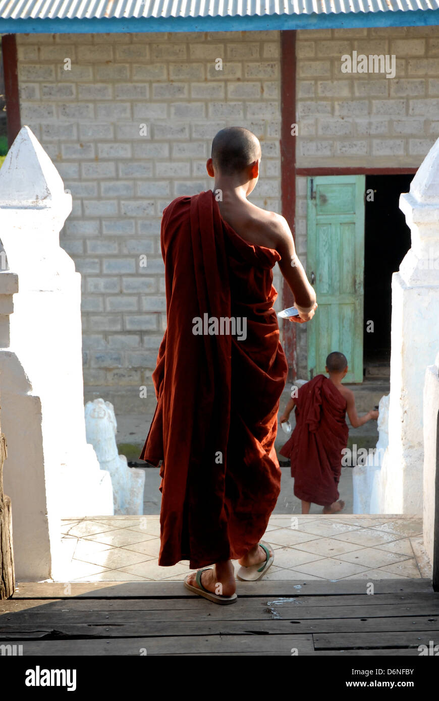 Monk walking down temple stairs in Mayanma (Burma Stock Photo Alamy