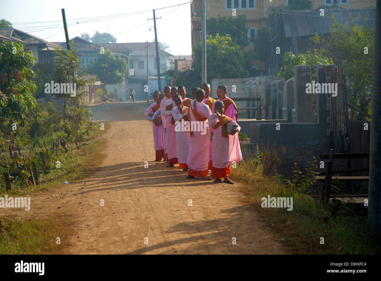 Buddist nuns collecting food hand outs in Myanmar (Burma) Stock Photo