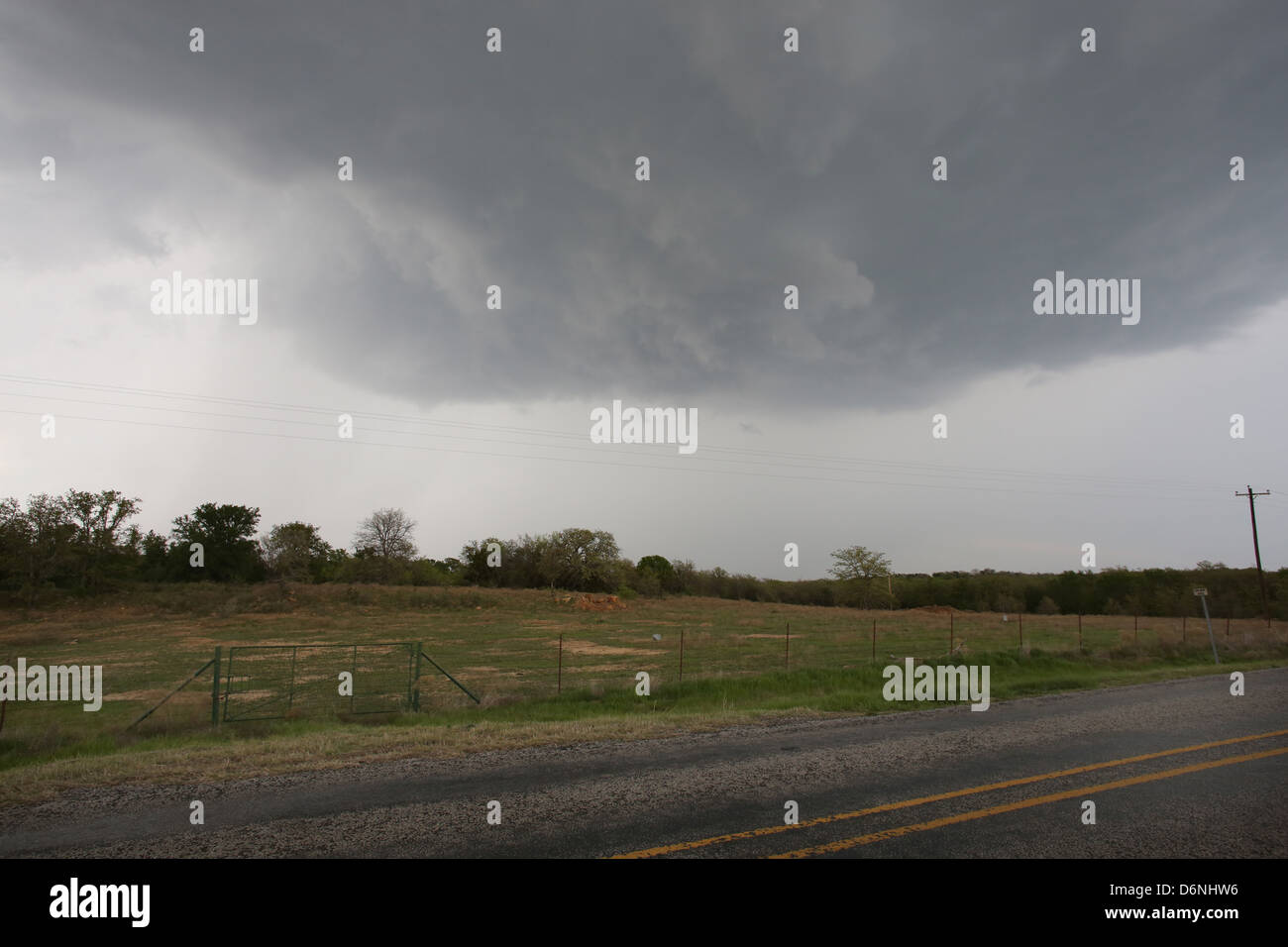 A large storm cloud over a field in the Midwest. Stock Photo