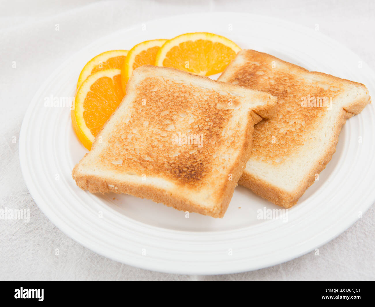 Healthy breakfast of white bread lightly toasted, served plain with a