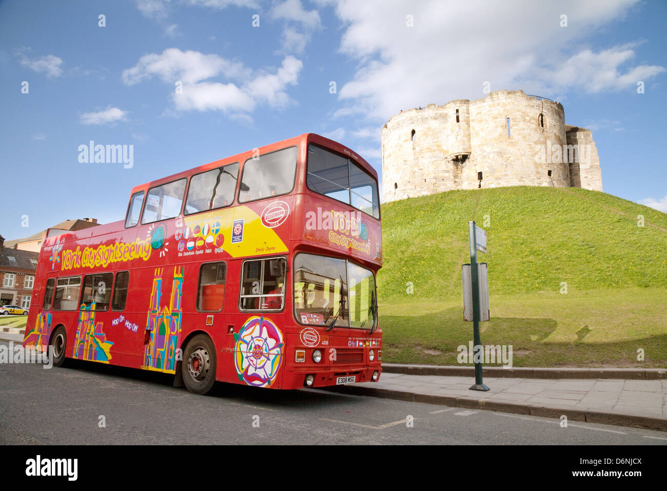 A red double decker York tourist bus sight seeing tour at Cliffords Tower, York castle, Yorkshire UK Stock Photo