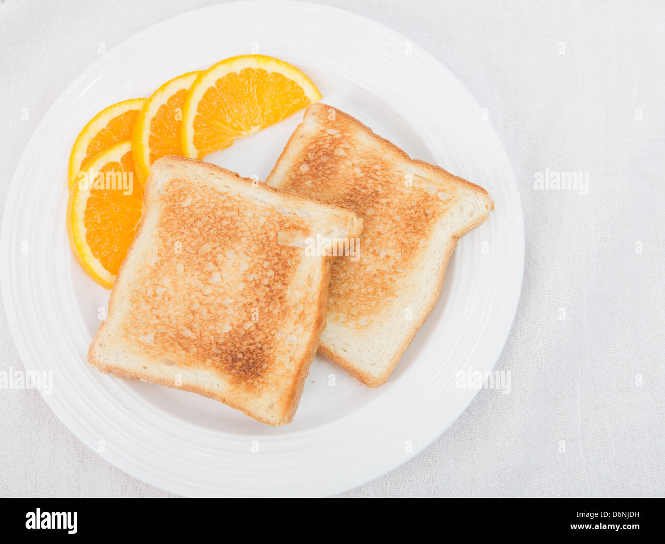 Healthy breakfast of white bread lightly toasted, served plain with a