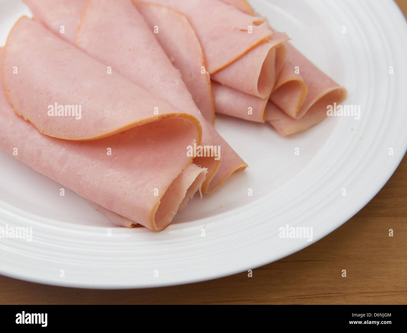 Plate of thinly sliced deli ham Stock Photo