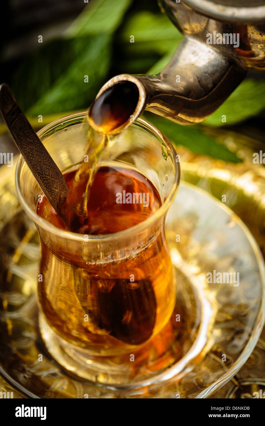 Pouring mint tea into Turkish glass Stock Photo